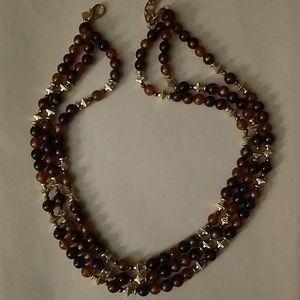 L R triple strand brown and gold tone bead necklac
